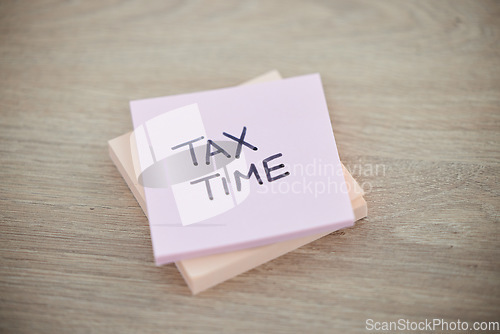 Image of Tax, planning and sticky note with reminder for finance, audit and wealth on a desk. Accounting, payment and paper with a message for taxation deadline, returns and strategy with money on a table