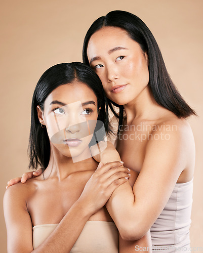 Image of Beauty, skincare and diversity women friends in studio for dermatology, makeup and cosmetics. Asian and black person together for skin glow, wellness spa facial and love of inclusion for foundation