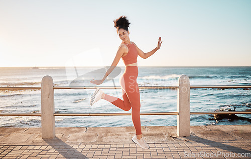 Image of Fitness, happy running and woman jumping on beach path on fun morning exercise with freedom and happiness. Run, jump and smile, excited girl on healthy ocean walk with joy, wellness and workout goals