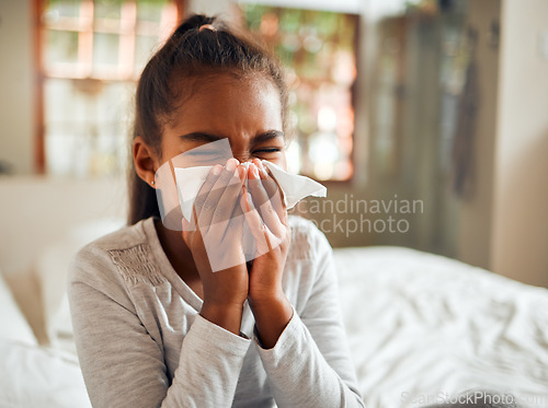 Image of Health, covid and sick black girl blowing nose in home bedroom. Wellness, healthcare and kid with tissue to wipe for virus, infection or cold, flu or fever, allergy or corona illness in house alone.