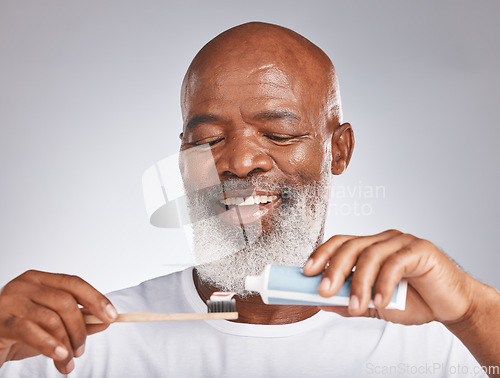 Image of Dental, toothbrush and product with face of black man for oral hygiene, teeth cleaning and self care. Beauty, cosmetics and grooming with senior model and toothpaste for brushing teeth and health