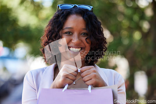 Image of Shopping, happy and portrait of a woman in the city for fashion discount, luxury sale and boutique gift in USA. Retail, present and face smile of a girl with a shopping bag with brand clothes