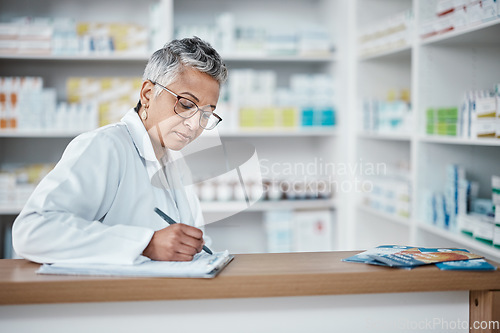 Image of Pharmacy, woman and checklist on clipboard, paperwork and inventory management in wellness store. Mature female pharmacist writing notes for stocks manager, medicine product or retail health services