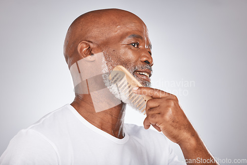 Image of Elderly, black man with comb for beard, beauty and grooming with hygiene and cosmetic care against studio background. Hair care mockup, brush body hair and face with hair treatment and cosmetics