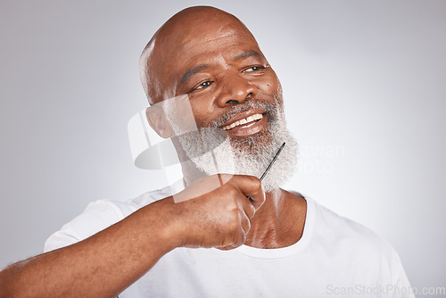 Image of Elderly, black man with comb for beard, beauty and grooming with hygiene and cosmetic care against studio background. Facial hair mockup, brush body hair and male face, hair treatment and cosmetics