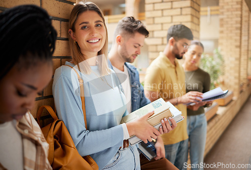 Image of University, lobby and portrait of woman and students standing in row together with books at business school. Friends, education and future, girl from USA in study group on campus in corridor for exam