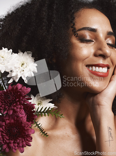 Image of Wellness, flowers and beauty aesthetic model with skincare satisfaction and glowing texture routine. Aesthetic, health and makeup of black woman cosmetics model with beautiful smile in white studio