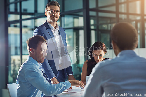 Image of Business people, office and meeting for strategy, planning and success with teamwork, vision and leader. Businessman, leadership and group at desk with woman, black man and documents for innovation