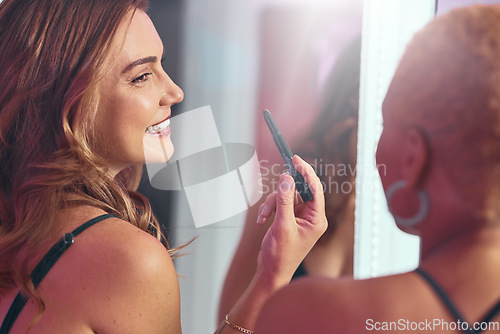 Image of Makeup, girl friends and getting ready by a mirror with a smile ready for a party. Lipstick, cosmetics and happy person laughing with cosmetic product and skin glow smiling with a friend at a club