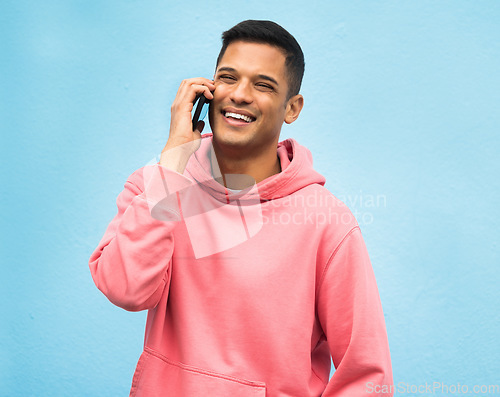 Image of Casual man, phone call and smile for communication standing isolated on a blue background. Happy male, person or guys with pink jacket in discussion, conversation or talking on mobile smartphone