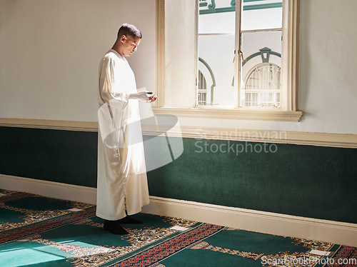 Image of Muslim, prayer or man in a mosque praying to Allah for spiritual mindfulness, support or wellness in Doha, Qatar. Religion, peace or Islamic person in temple to worship or praise God with gratitude