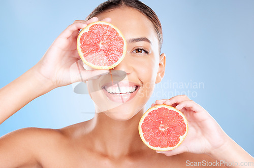 Image of Beauty, grapefruit and woman with face and natural cosmetic care, facial and glow with vegan product against studio background. Skincare, healthy skin and wellness with fruit, hands and cosmetics.