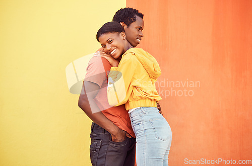 Image of Couple, love or bonding hug by city wall background in trust, security or support in relax urban date, fun activity or holiday. Portrait, happy smile or black woman and man embrace on building mockup