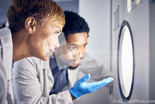 Image of Science, man and woman in laboratory, research and test sample for cure, vaccine or conversation. Researchers, scientist or staff talking, data analysist and check experiment for innovation or expert