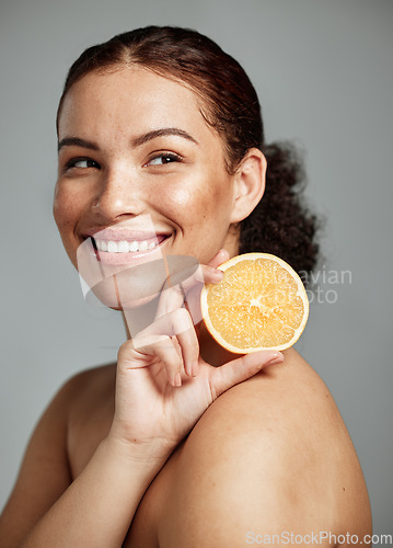 Image of Woman, happy and orange in studio for skincare, wellness and beauty with cosmetic glow, self care and backdrop. Model, black woman and fruit for aesthetic, detox or healthy natural skin by background