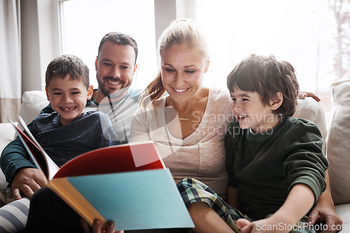 Image of Family, couple and children on sofa for storytelling time with books and learning in family home. Love, reading and children, mother and father with fantasy book on couch, smile and fun in apartment.