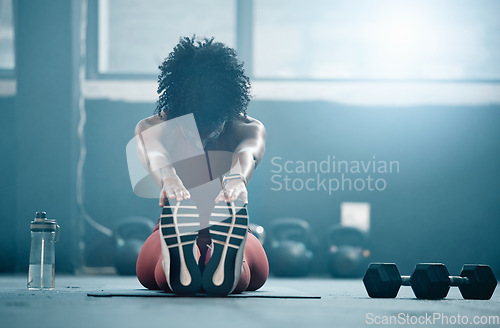 Image of Fitness, mockup and a black woman stretching in the gym with dumbbells while holding her feet. Health, exercise and weightlifting with a female athlete doing her warm up routine in a workout center