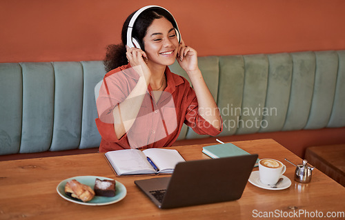 Image of Headphone, cafe and black woman with music or web podcast working on a computer. Student learning, streaming and radio listening of a happy young person at a coffee shop ready for digital study