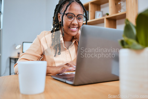 Image of Laptop, research and report with a freelance black woman doing remote work online from her home office. Computer, small business and typing with a female employee or entrepreneur at work in a house