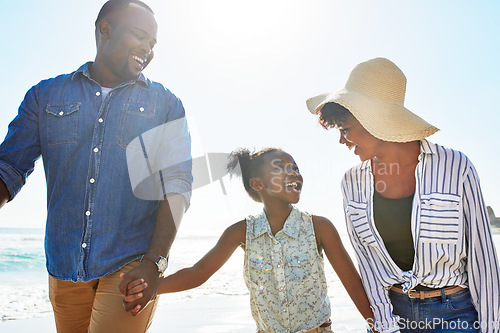 Image of Black family, happy and walking on a beach with child or kid on vacation or holiday at the ocean or sea. Travel, sunshine and African parents relaxing with daughter holding hands together on a trip