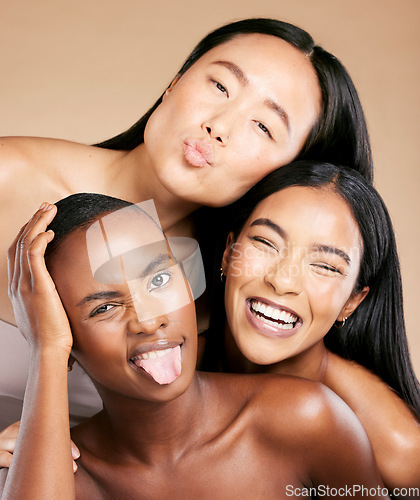 Image of Diversity, beauty and women in crazy portrait smile together, skincare friends on studio background. Health, wellness and luxury cosmetics for beautiful multicultural people in makeup with tongue out