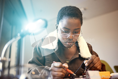 Image of Black woman, student and engineer with electrical project while learning and studying. Education, engineering or technician at college with technology voltage meter for electricity and innovation