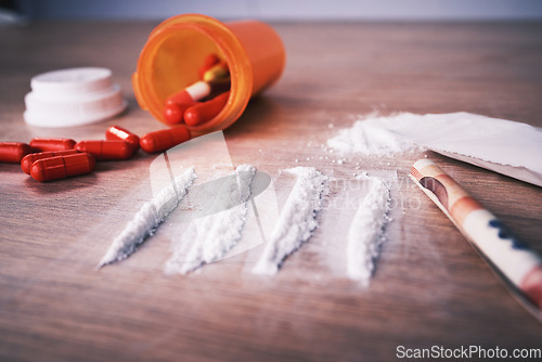 Image of Drugs, addiction and cocaine on table with pills, social problem and crime in narcotics. White powder, mental health and rehabilitation to stop addictive substance abuse and trafficking illegal drug.