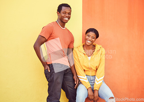 Image of Black couple, smile and urban portrait by wall with edgy fashion, happy and bonding with color. Gen z, happy couple and city wall background with orange, yellow and love on adventure in Atlanta metro