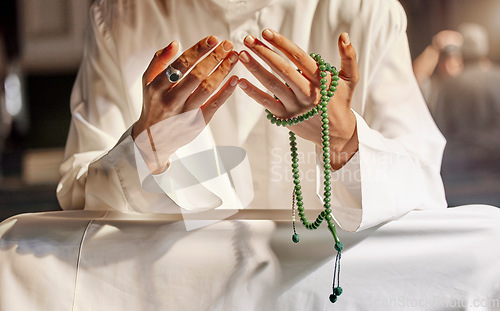 Image of Hands, prayer beads and muslim man praying in mosque, temple or church. Islam, worship and islamic male with beads for worshiping Allah, God or holy spirit for hope, spiritual faith and religion.