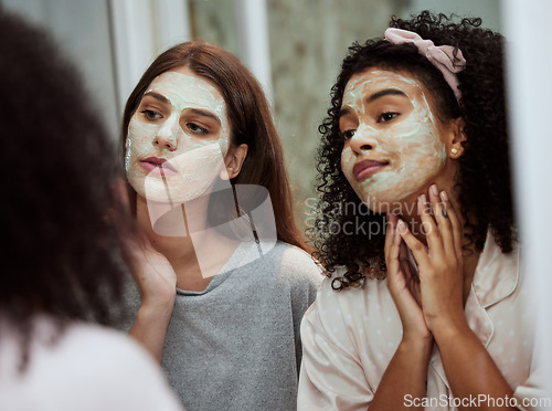 Image of Women, home skincare or face mask bonding in house, bathroom or hotel for spa wellness, girls hospitality or healthcare grooming. Friends, people or beauty facial product for luxury wellness cleaning