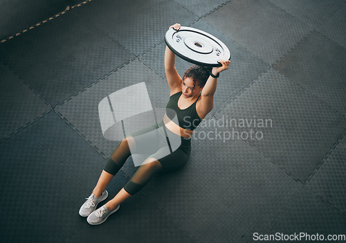 Image of Fitness, weight plate and woman at gym for workout, exercise and training for health and body wellness. Top view of strong sports female or bodybuilder on floor weightlifting for power and balance