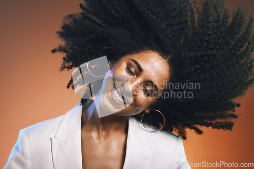 Image of Hair, afro and black woman, beauty with smile on face and cosmetic and hair care with happiness against studio background. Dance, natural curly hair texture and makeup with earrings and freedom