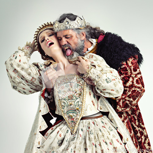 Image of King, queen and love of couple in studio isolated on a gray background. Vintage royalty, retro victorian and affection, romance and passion of royal man and woman with crown kissing, embrace and hug.