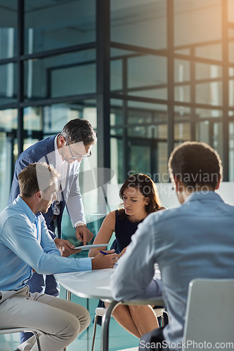 Image of Man, tablet and business people in meeting for coaching, goals and mission at desk for discussion. Teamwork, woman and strategy for vision, collaboration or innovation in financial company with coach