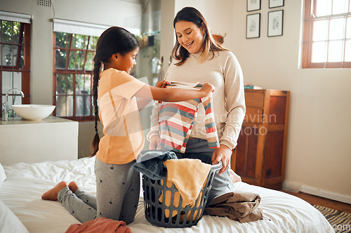 Image of Laundry, pregnant mother and child help with house chores and cleaning with love and care. Folding clothes, happy and working family in a bedroom bed busy with clean clothing fold in a house