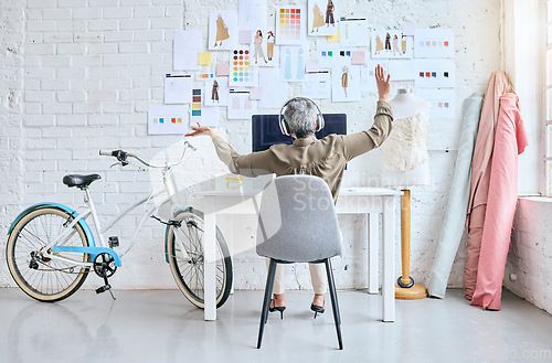 Image of Creative, startup and woman listening to music, dancing and mental health wellness in fashion design workshop. Textile industry worker, person or supplier with headphones, audio and dance at her desk