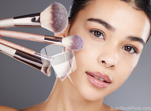 Image of Makeup, portrait or woman brushes her face with facial cosmetics or luxury skincare products. Glow, aesthetic or beautiful girl model grooming in self care routine isolated on studio background