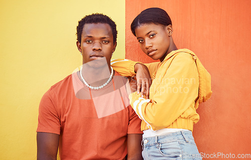 Image of Fashion portrait of African couple, people or friends relax with designer brand clothes, casual style and luxury apparel. Urban gen z aesthetic, black woman and man on orange yellow background wall