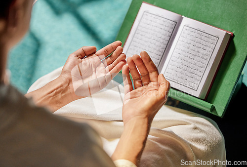 Image of Quran, muslim and man hands praying to allah, god or holy spirit for islamic religion, faith and Saudi Arabia Hajj. Spiritual book, Eid hope prayer and Islamic person worship in moslem mosque church