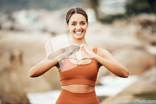 Image of Fitness portrait, hands heart and woman in nature for health or wellness. Sports, training and face of female athlete with emoji for love, affection and romance outdoors getting ready for practice.