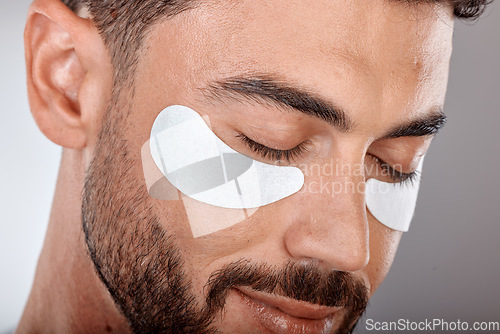Image of Skincare, beauty and man with mask for eyes on gray background for wellness, facial treatment and dermatology. Grooming, luxury spa and male with face patch, eye pads and cosmetics products in studio