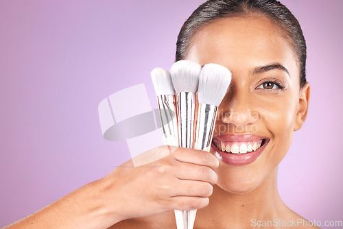 Image of Beauty, cosmetics and woman with brushes for makeup on purple background for skincare, fashion and style. Cosmetology, aesthetic and girl with brush set for foundation, beauty products and facial