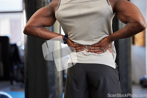 Image of Black man, fitness or back pain in gym workout, exercise or training and body anatomy crisis, muscle burnout or spinal tension. Sports athlete, personal trainer or coach with injury or health problem