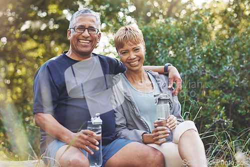 Image of Nature, hiking and portrait of a senior couple resting while doing outdoor walk for exercise. Happy, smile and elderly man and woman in retirement trekking together for wellness in a forest in Brazil