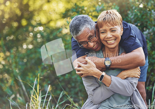Image of Nature, love and man hugging his wife with care, happiness and affection while on an outdoor walk. Happy, romance and portrait of a senior couple in retirement embracing in the forest, woods or park.