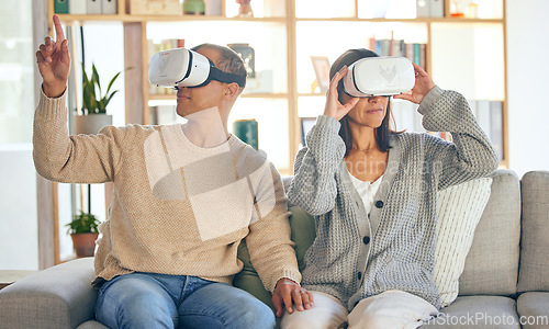 Image of Virtual reality, 3d and a couple in the interactive metaverse while together on a sofa in the living room of a home. VR, goggles and gaming with a man and woman in their house to relax or video game