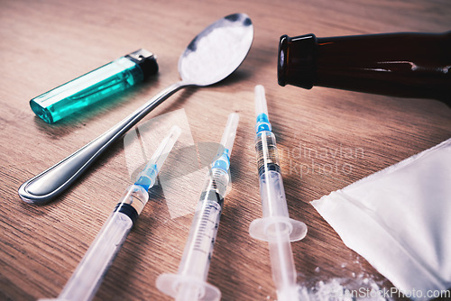 Image of Drugs, syringe and podwer with spoon on table for alcohol addiction, drug rehabilitation and narcotics abuse. Medicine, illegal pharmaceuticals and meth, cocaine and heroin solution for drug problem