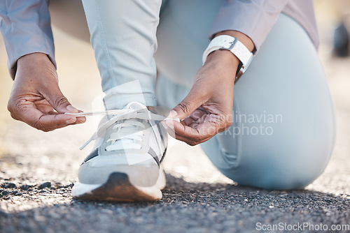 Image of Woman, hands and shoelace for street runner, outdoor workout and fitness in summer sunshine in morning. Running adventure, shoes and tie lace for safety, speed and balance in road exercise for health