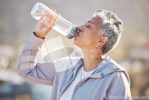 Image of Fitness, health and senior woman drinking water for hydration on outdoor cardio run, exercise or retirement workout. Marathon training, bottle and profile of runner running in Rio de Janeiro Brazil