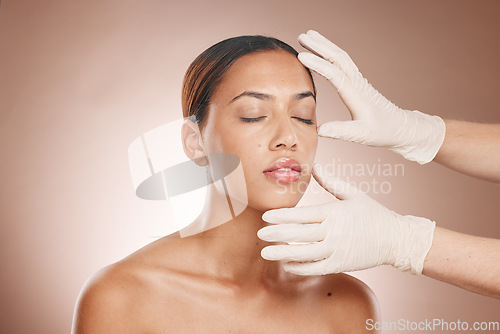 Image of Plastic surgery, woman and doctor hands check face for botox, beauty implant and makeup cosmetics. Skincare consultation, facial and gloves for aesthetics, filler and body change on studio background